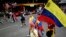 A woman holds a Venezuelan flag during a protest against the result announced for the Venezuelan presidential election at the Reforma Avenue in Mexico City on Aug. 10, 2024. 