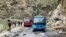 Security personnel inspect the site of a suicide attack near Besham city in the Shangla district of Khyber Pakhtunkhwa province on March 26, 2024.