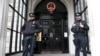 FILE - Policemen stand guard outside China's Embassy in London, Britain, Oct. 18, 2015. A statement issued Sunday by the diplomatic mission called a visit by British lawmakers, planned for Monday, a "gross interference in China's internal affairs."