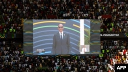 Rwanda President Paul Kagame is seen on screen moments after taking the oath of office in front of supporters during the Presidential Inauguration ceremony at the Amahoro stadium in Kigali, Aug. 11, 2024. 