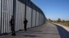FILE - Police border guards patrol along a border wall near the town of Feres, along the Evros River which forms the the frontier between Greece and Turkey, Oct. 30, 2022. 