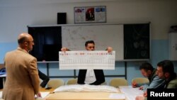 Officials count votes on the day of the presidential and parliamentary elections in Istanbul, May 14, 2023. 