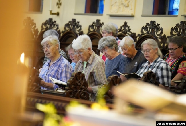 Sisters join in song during evening prayer at the Mount St. Scholastica Benedictine monastery in Atchison, Kan., Tuesday, July 16, 2024. (AP Photo/Jessie Wardarski)