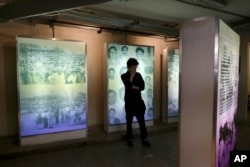 FILE - A visitor looks at an exhibit during the inauguration of a memorial to victims of Mexico's 'dirty war' at the former Federal Security headquarters where protesters were taken in 1971 following a violent crackdown in Mexico City, June 10, 2019.