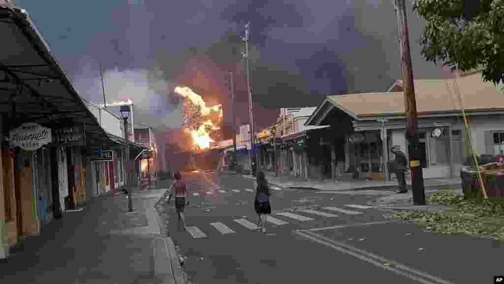 People watch as smoke and flames fill the air from raging wildfires on Front Street in downtown Lahaina, Maui, Aug. 8, 2023.