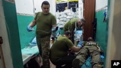 Ukrainian military medics treat a soldier with a concussion in a field hospital in Donetsk region, Ukraine, June 22, 2023.