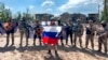 In this handout photo taken from video and released by Prigozhin Press Service May 20, 2023, Yevgeny Prigozhin, the head of the Wagner Group military company speaks holding a Russian flag in front of his soldiers in Bakhmut, Ukraine. 
