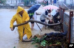 Residents remove debris from a flooded area in the town of Volos, central Greece, Sept. 5, 2023.