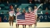 Simone Biles, center, and her teammates celebrate after Team USA won the artistic gymnastics women's team final during the Paris 2024 Olympic Games at the Bercy Arena in Paris, on July 30, 2024. 