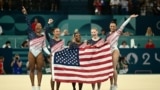 Simone Biles, center, and her teammates celebrate after Team USA won the artistic gymnastics women's team final during the Paris 2024 Olympic Games at the Bercy Arena in Paris, on July 30, 2024. 