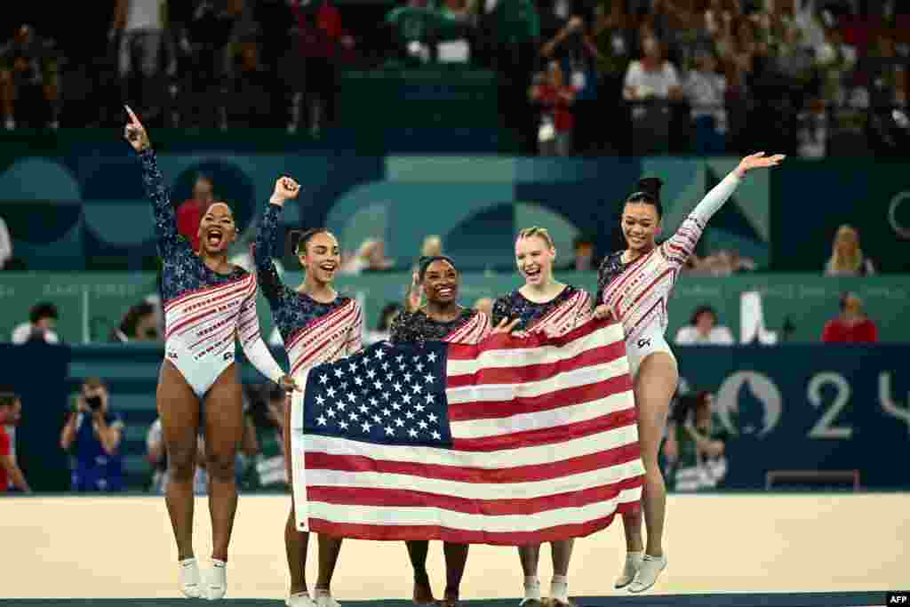 Simone Biles, center, and her teammates celebrate after Team USA won the artistic gymnastics women&#39;s team final during the Paris 2024 Olympic Games at the Bercy Arena in Paris, July 30, 2024.