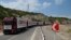 FILE - Trucks with humanitarian aid for Artsakh sit parked in a road toward the separatist region of Nagorno-Karabakh, in Armenia, July 28, 2023.