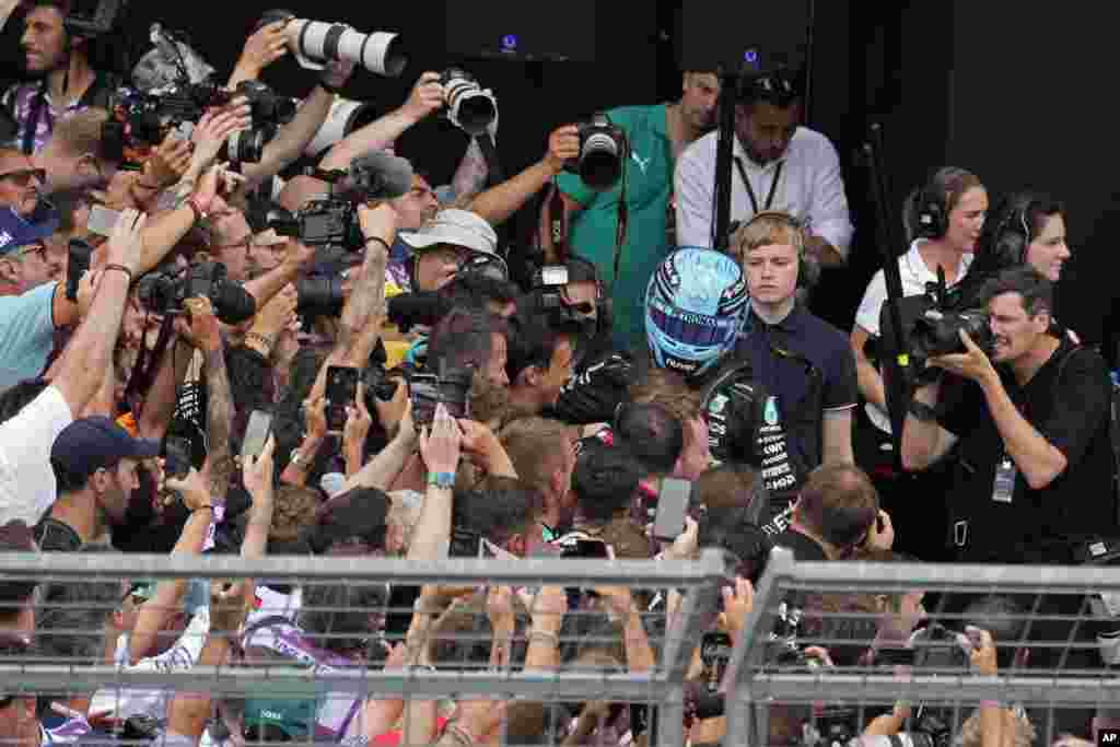 Photographers struggle to take photos of Mercedes driver George Russell of Britain after he won the Austrian Formula One Grand Prix race at the Red Bull Ring racetrack in Spielberg, Austria.
