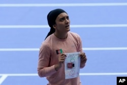 Kimia Yousofi, of Afghanistan, makes a political statement after a heat in the women's 100-meter run at the 2024 Summer Olympics, Aug. 2, 2024, in Saint-Denis, France.