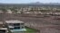 FILE - A home with a swimming pool abuts the desert on the edge of the Las Vegas valley in Henderson, Nevada, July 20, 2022.