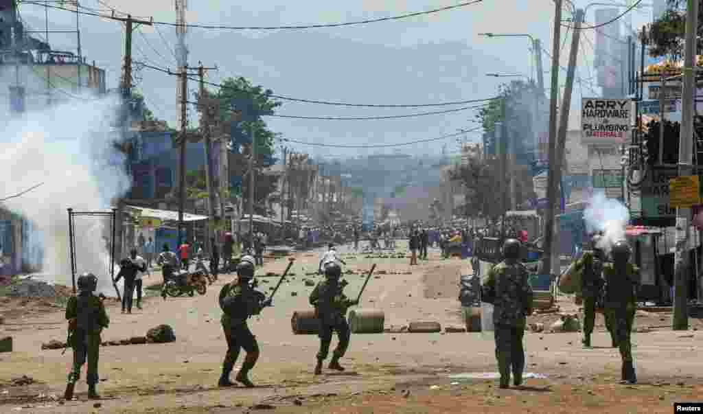 Riot police officers lob teargas canisters to disperse supporters of Kenya&#39;s opposition leader Raila Odinga of the Azimio La Umoja (Declaration of Unity) One Kenya Alliance, during protests over cost of living and Kenyan President William Ruto&#39;s government, in Kisumu.