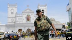 FILE- In this Apr. 21, 2019 file photo, Sri Lankan army soldiers secure the area around St. Anthony's Shrine after a blast on Easter Sunday in Colombo, Sri Lanka. 