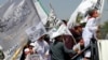 Children of Taliban fighters hold Taliban flags as they celebrate the third anniversary of the withdrawal of US-led troops from Afghanistan, in Kabul, Aug. 14, 2024. 