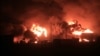 A giant fire erupts at an oil storage facility following Israeli strikes in Yemen's Huthi-held port city of Hodeida, July 20, 2024.