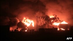 A giant fire erupts at an oil storage facility following Israeli strikes in Yemen's Huthi-held port city of Hodeida, July 20, 2024.