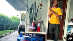 Chris Cole speaks to the Associated Press about evacuating from last year's wildfires as he displays an emergency kit and a bag with essentials that he can quickly grab if he has to flee flames again at his home, July 18, 2024, in Kula.