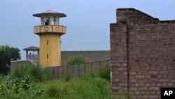 Police officers stand guard on the watch towers of district prison Attock, where Pakistan's former Prime Minister Imran Khan in-prison after his conviction, in Attock, Pakistan, Aug. 6, 2023. 