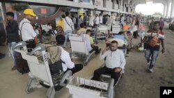 Passengers wait at Hazrat Shahjalal International Airport's Departure Terminal days ahead of their scheduled flight due to ongoing curfew in Dhaka, July 22, 2024. Internet and mobile data services are still down despite apparent calm in the country. 