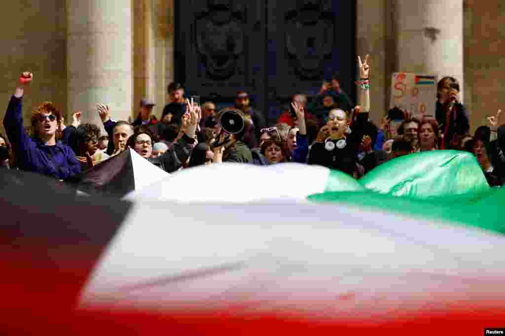 Students hold a giant Palestinian flag as they gather in front of the Sorbonne University in Paris, France, in support of Palestinians in Gaza.