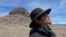 FILE - Gary McKinney, a spokesperson for People of Red Mountain and a member of the nearby Duck Valley Shoshone-Paiute Tribe, walks near Sentinel Rock on April 25, 2023, outside of Orovada, Nev. 