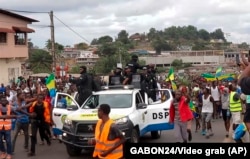 This video grab shows coup supporters cheering police officers in Libreville, Gabon, Aug. 30, 2023.