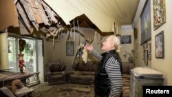 A resident stands in a flat, in an apartment building destroyed by a Russian missile strike, amid Russia's attack on Ukraine, in Dnipro, Ukraine May 9, 2023.