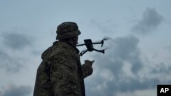 A Ukrainian soldier launches a drone near Bakhmut, the site of fierce battles with Russian forces, in Ukraine's Donetsk region, Sept. 3, 2023.