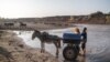 FILE - A youngster fills a water in the Shabelle river in the city of Gode, Ethiopia, on Jan. 14, 2023.