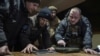 A Ukrainian commander of a unit aka Kurt (right) speaks to his comrades at the frontline in Ukraine, Feb. 13, 2023. (AP/Evgeniy Maloletka)