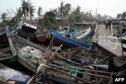 Broken boats are piled up next to a brokken bridge in Sittwe, in Myanmar's Rakhine state, on May 15, 2023, after cyclone Mocha made a landfall. Cyclone Mocha made landfall between Cox's Bazar in Bangladesh and Myanmar's Sittwe carrying winds of up to 195 kilometres (120 miles) per hour, the biggest storm to hit the Bay of Bengal in more than a decade.