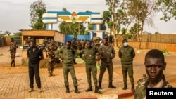 Members of Niger's security forces stand guard as pro-junta supporters take part in a demonstration in front of a French army base in Niamey, Aug. 11, 2023. The new U.S. ambassador to Niger, Kathleen FitzGibbon, will arrive in Niamey, the State Department said Aug. 16.
