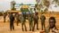 Members of Niger's security forces stand guard as pro-junta supporters take part in a demonstration in front of a French army base in Niamey, Aug. 11, 2023. The new U.S. ambassador to Niger, Kathleen FitzGibbon, will arrive in Niamey, the State Department said Aug. 16.
