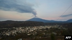 Ash and smoke billow from the Popocatepetl volcano as seen from the Santiago Xalitzintla community, state of Puebla, Mexico, on May 24, 2023. 