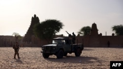 FILE - French soldiers of the Barkhane force patrol the streets of Timbuktu, northern Mali, on December 5, 2021.