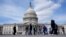 FILE - Visitors walk outside of the U.S. Capitol, March 19, 2024, in Washington. 