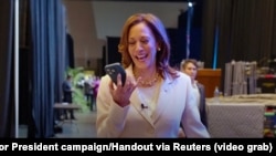 U.S. Vice President Kamala Harris speaks on the phone with former President Barack Obama and former first lady Michelle Obama as they endorse Harris as the Democratic presidential candidate in this image taken from a video released July 26, 2024. 