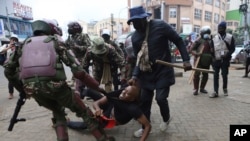 A protester is arrested in Nairobi, Kenya, Aug. 8, 2024, during a demonstration against hunger. 