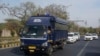Security vehicles escort a police van carrying Arvind Kejriwal, leader of the Aam Admi Party, or Common Man's Party, to Tihar prison from a local court, in New Delhi, India, April 1, 2024. 
