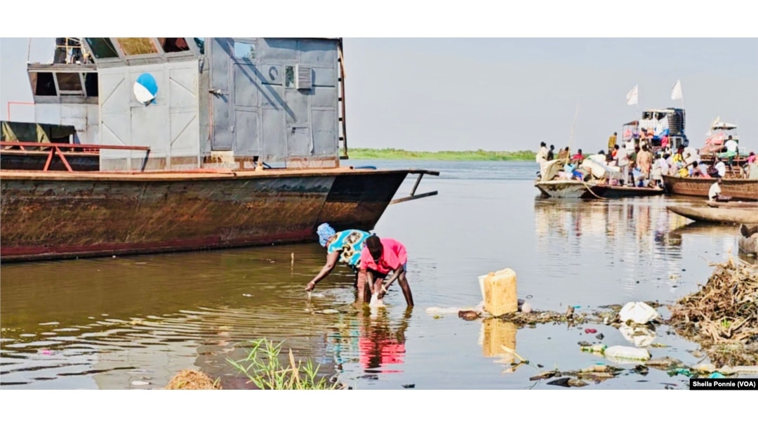 A boy and a woman wash intestines from a slaughterhouse in the Nile River, in Bor, Jonglei State, South Sudan.