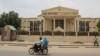 A motorcyclist drives past the Constitutional Council building in N'Djamena on March 14, 2024. Chad's Constitutional Council says it is examining the files of about 20 candidates in the race for the central African state's May 6 presidential polls. 