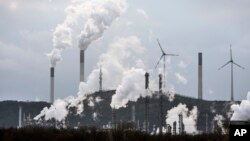 FILE - The industrial backdrop of a BP refinery and a Uniper coal-fired power plant is seen in Gelsenkirchen, Germany, March 6, 2023. 