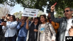 FILE—Journalists demonstrate in solidarity with Tunisian columnist Haythem Mekki and radio presenter Elyes Gharbi (not pictured) outside the offices of el-Gorjani Criminal Brigade in Tunis on May 22, 2023