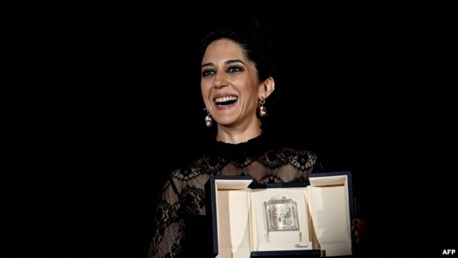 Iranian actress Zar Amir-Ebrahimi poses with her trophy after she won the Best Actress Prize for her part in