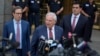 FILE - Former Senator Bob Menendez, center, speaks to reporters as he leaves federal court in New York, July 16, 2024.