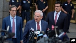 FILE - Sen. Bob Menendez, D-N.J., center, speaks to reporters as he leaves federal court in New York, July 16, 2024.